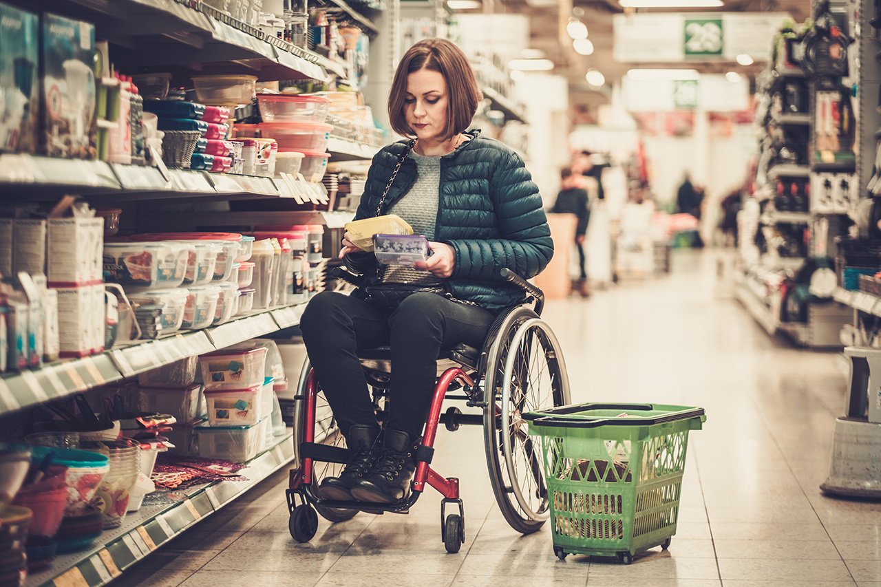 Disabled woman in a wheelchair in a store